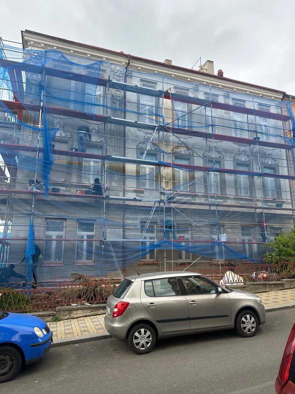 Apartment building in scaffolding — repair of a facade with stucco decoration